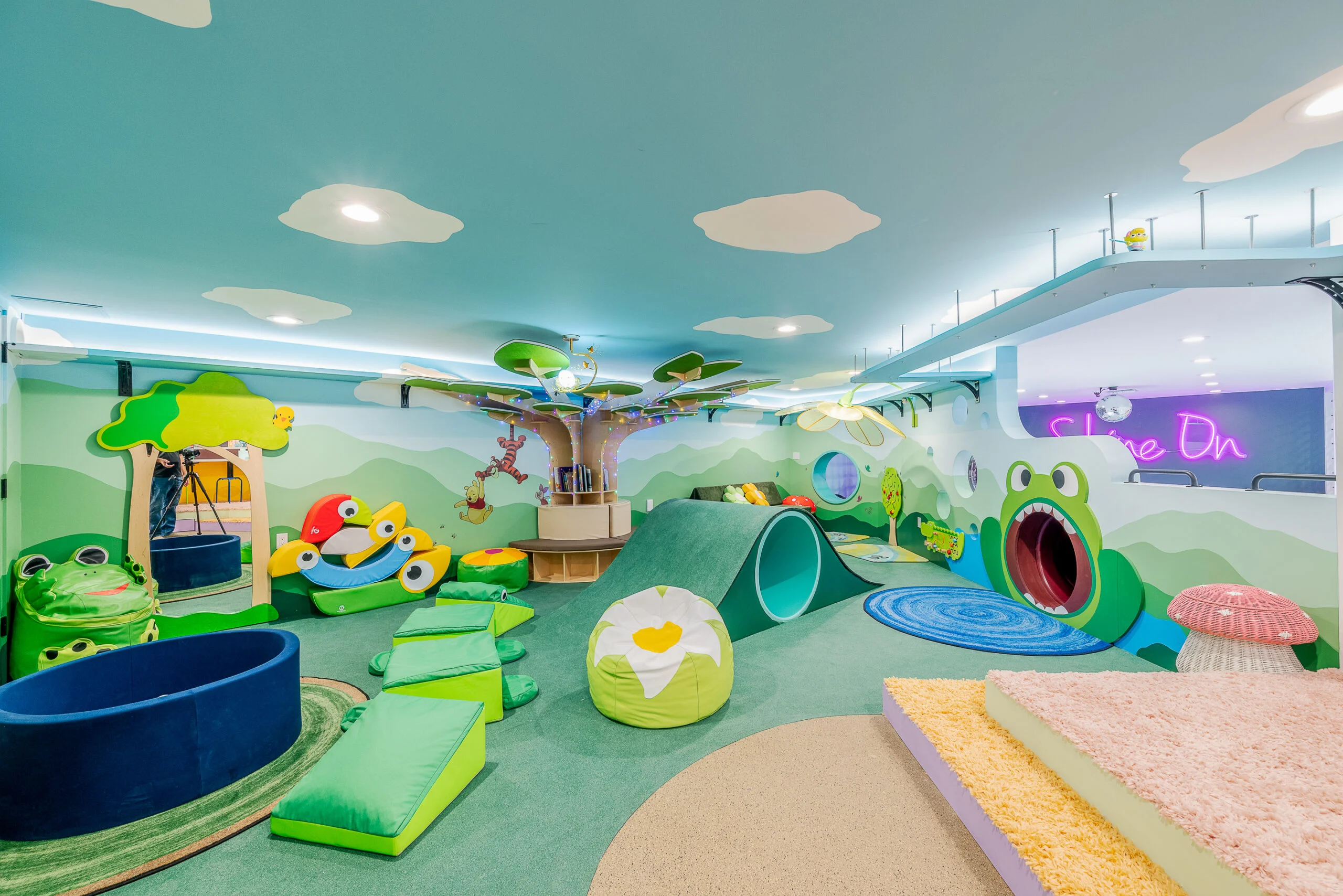 A colorful indoor children's playroom with a whimsical nature theme A colorful indoor children's playroom with a whimsical nature theme.
